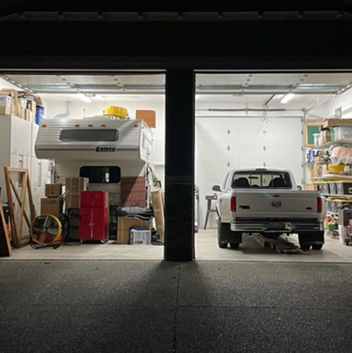 Garage interior illuminated by bright 8ft LED Tube 40W 7,200 lm Ballast Bypass lighting with organized storage and vehicles.