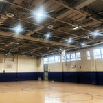 UFO LED High Bay lights installed in gymnasium illuminating court area with adjustable beam angles and wattage settings