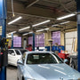 8ft LED Tube 40W FA8 Type B installed in a bright auto repair shop illuminating work areas efficiently