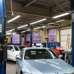 8ft LED Tube 40W FA8 Type B installed in a bright auto repair shop illuminating work areas efficiently