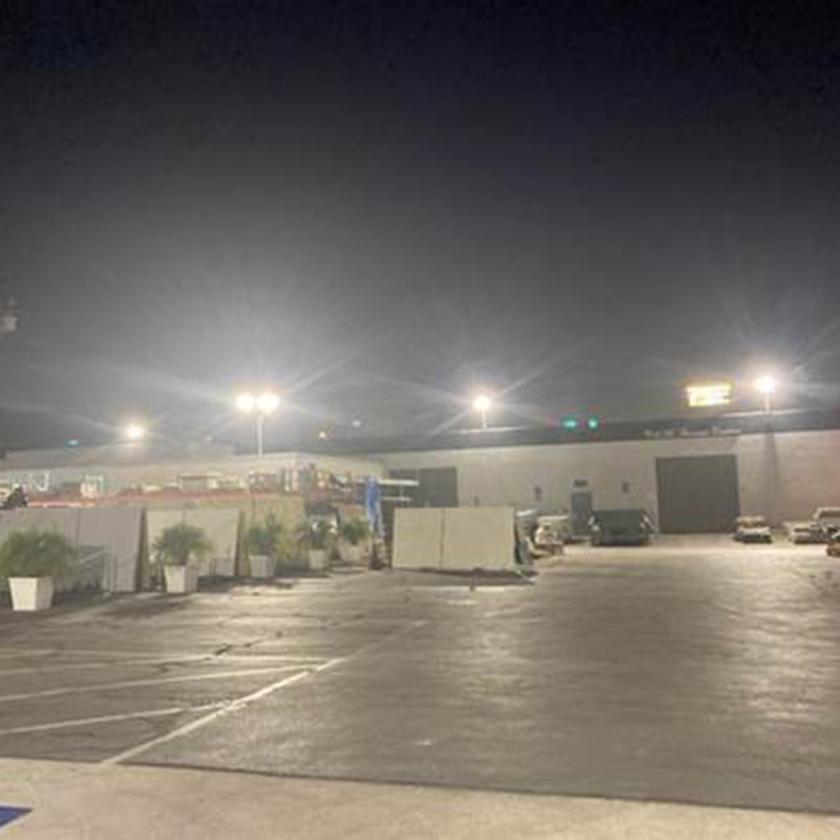 LUX LED Flood Light illuminating a large outdoor parking lot for bright and efficient nighttime visibility