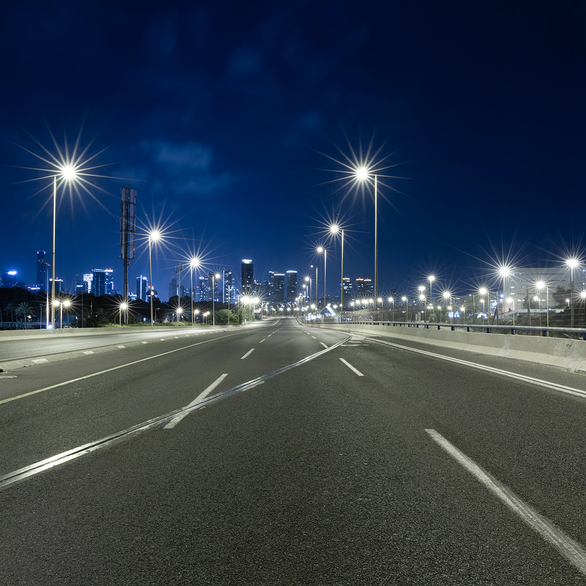 LED Shoebox Area Light - 3 CCT - Swappable Optics illuminating an empty urban road at night with clear visibility