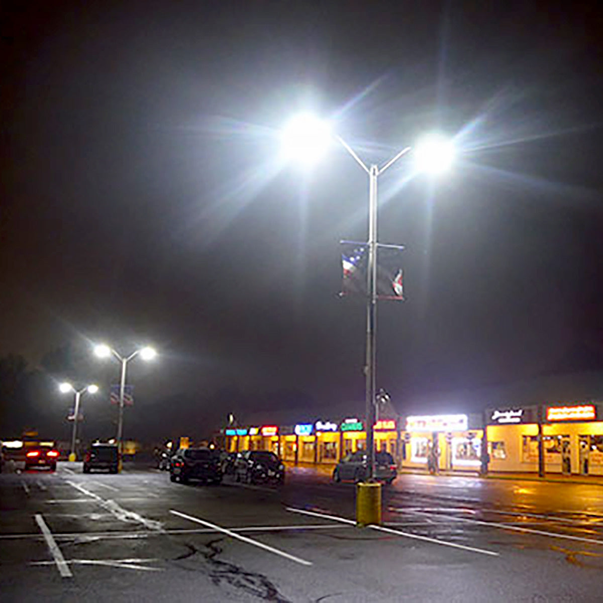 Outdoor parking lot illuminated at night with LED Shoebox & Wall Pack Retrofit 3 CCT 30W street lights