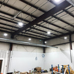 UFO LED High Bay lights installed in warehouse with adjustable beam angles and bright white illumination