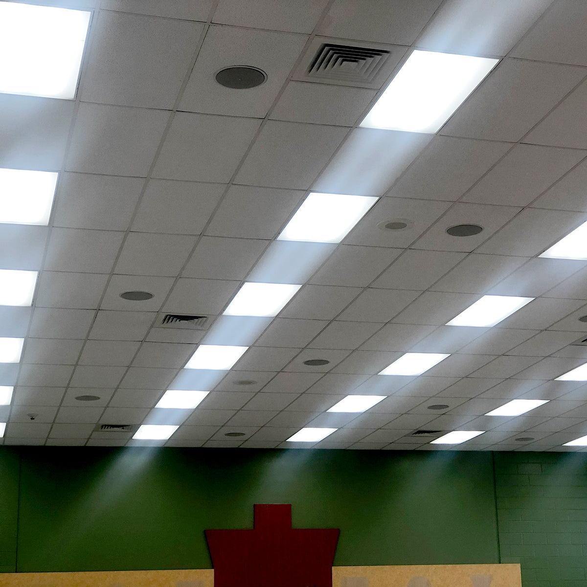 Bright LED ceiling lights installed in a large room using the LED High Lumen Magnetic Retrofit Kit for 2x4 Troffer