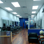 Bright modern salon interior illuminated by 2x4 LED Panel 40W RAB T34 fixtures in drop ceiling
